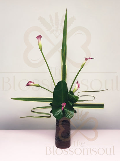 Attacher III - Japanese Modern Floral Arrangement featuring pink calla lilies, manipulated leaves, and vertical balance in a minimalist style.
