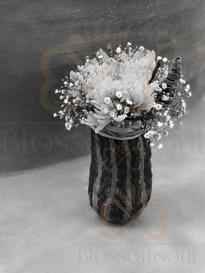 Black and white botanical digital artwork featuring a handcrafted floral arrangement in a green decorative pumpkin, with a single chrysanthemum bloom, baby’s breath flowers, coconut sticks, and raffia. Monochrome composition with natural textures, handcrafted and photographed in Dubai.