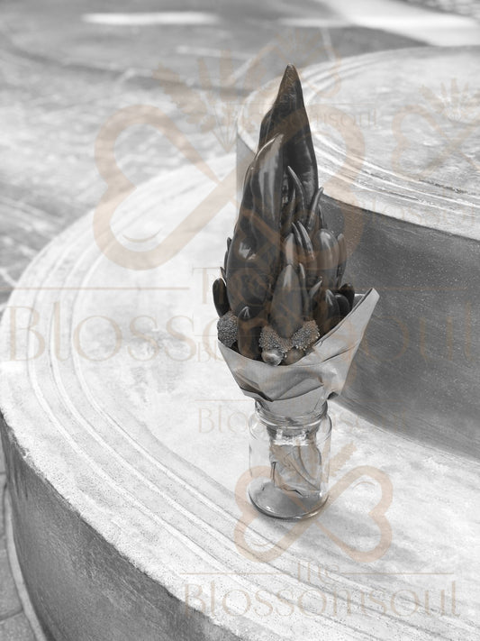 Monochrome botanical bouquet artwork featuring sculptural red capsicum, chili peppers, green bell pepper, baby cabbage, and broccoli arranged in a glass jar on a soft stone background. Black and white digital composition with high contrast textures and minimalist aesthetic.
